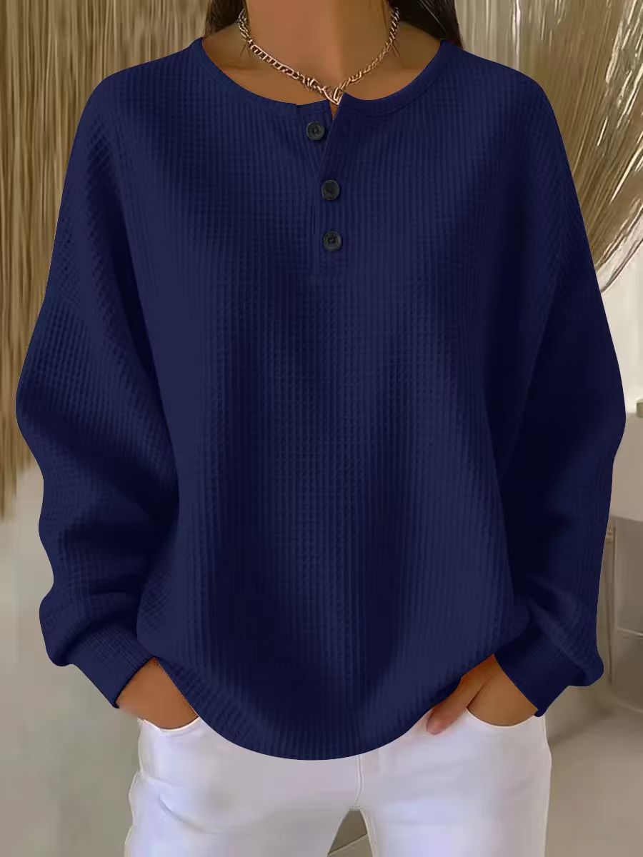Navy blue textured sweater worn by a person with a neutral background