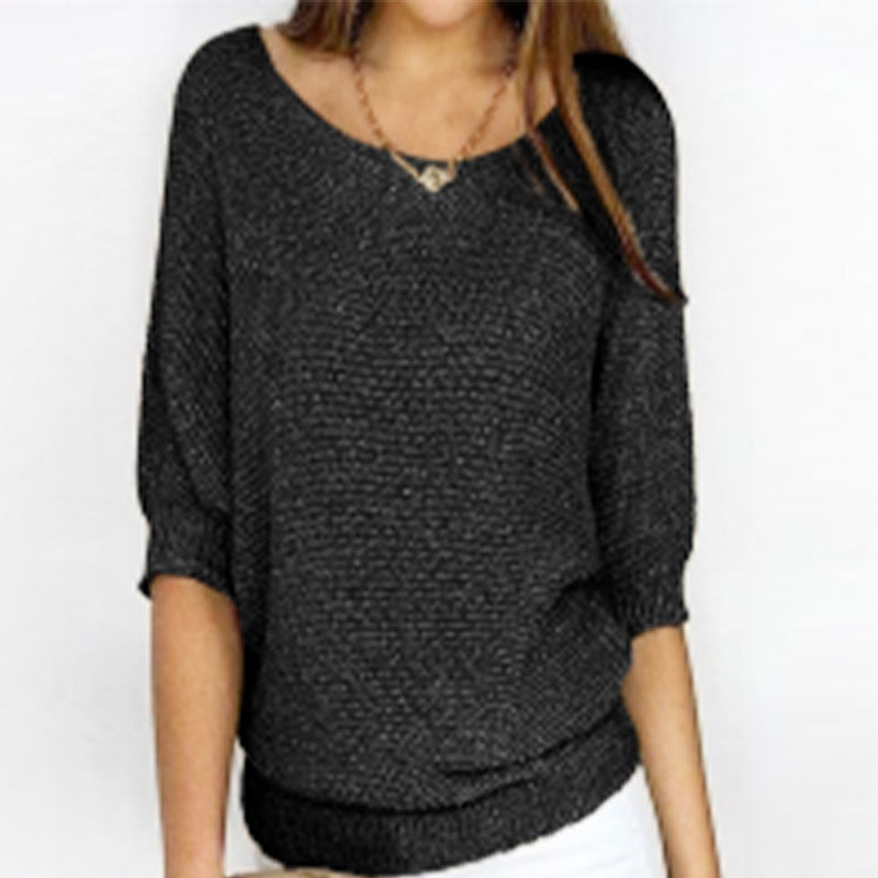 Dark gray textured sweater worn by a person on a white background