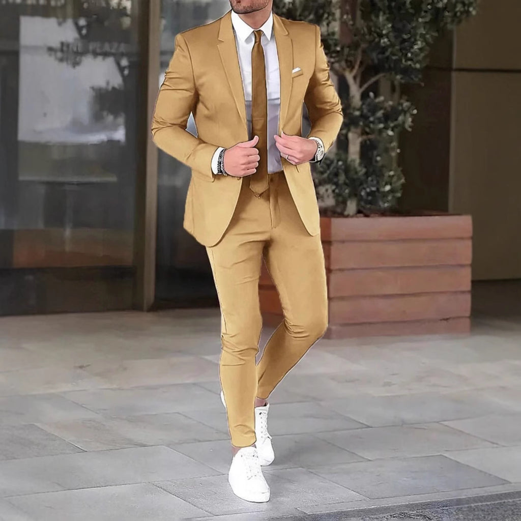 Man wearing a tan suit with white shoes in an outdoor setting