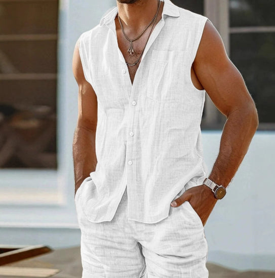 Man wearing a white sleeveless shirt and pants with a blurred background