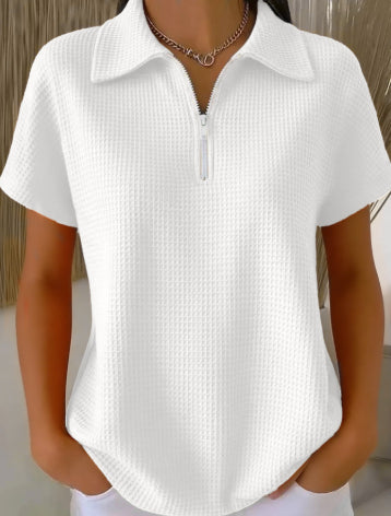 White textured short-sleeve shirt worn by a person with a neutral background