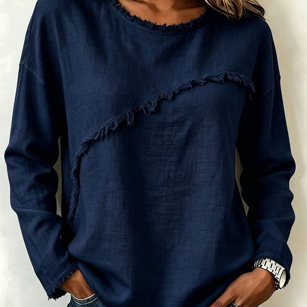 Navy blue long-sleeve top with frayed hem on a plain background
