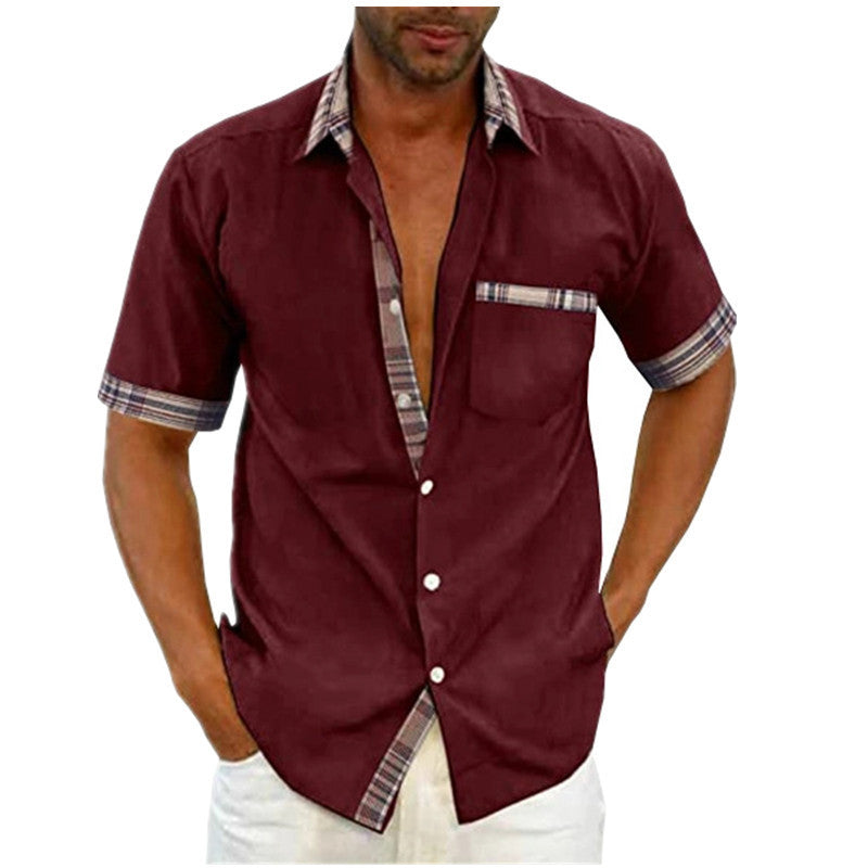 Man wearing a burgundy short-sleeve shirt with plaid accents on a white background