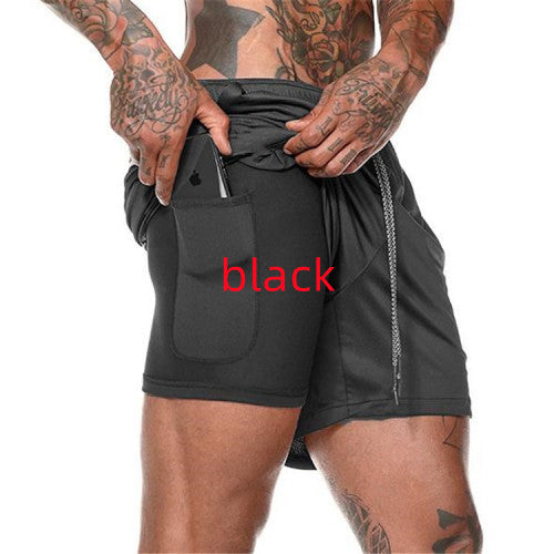 Person wearing black athletic shorts with a white background