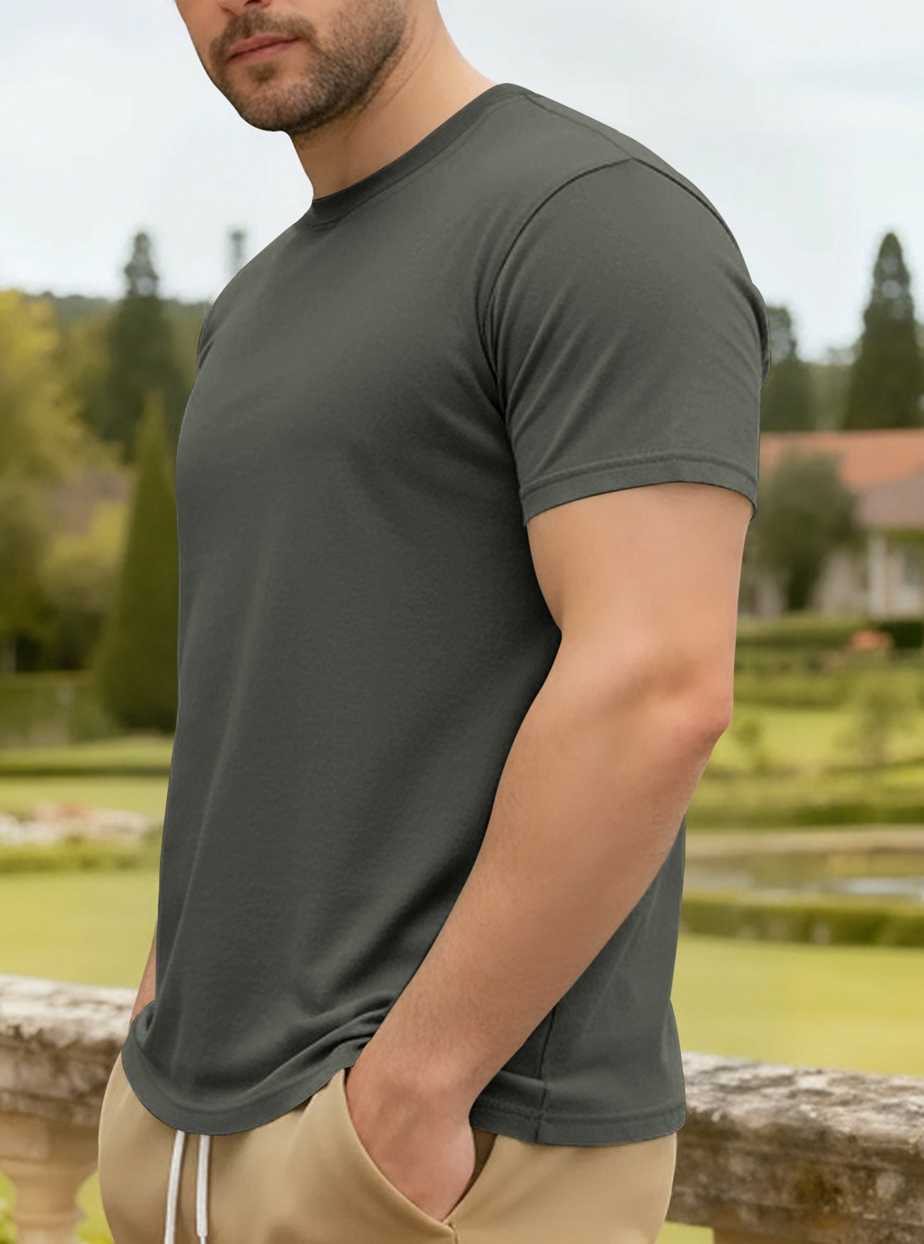 Man wearing a green t-shirt with a garden background