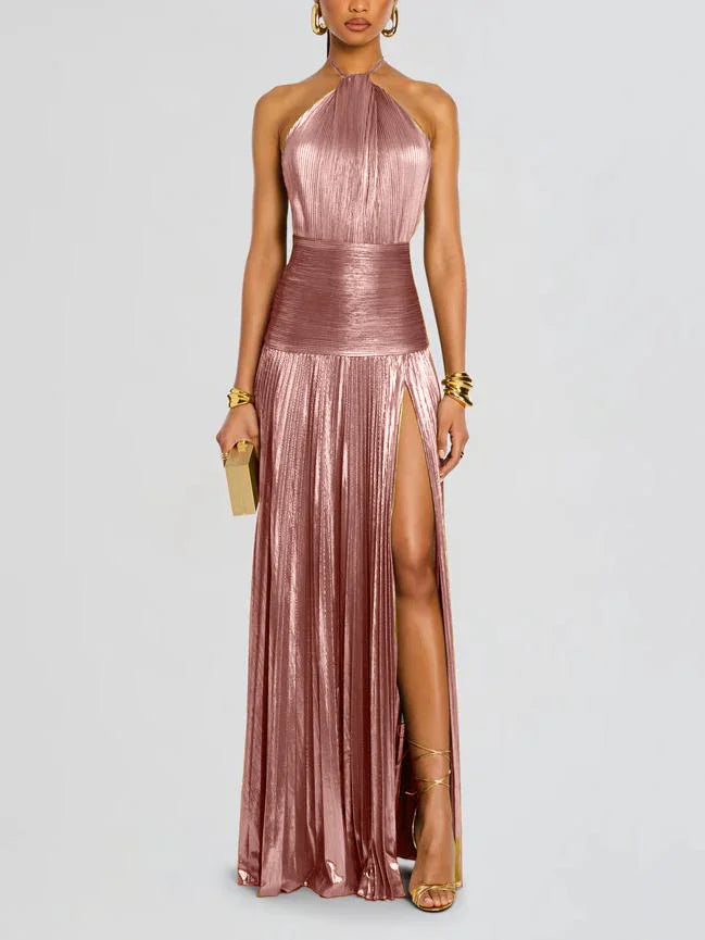 Woman wearing a metallic pink halter neck gown with a slit on a light gray background