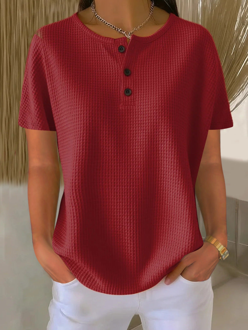 Red textured shirt worn by a person with a neutral background