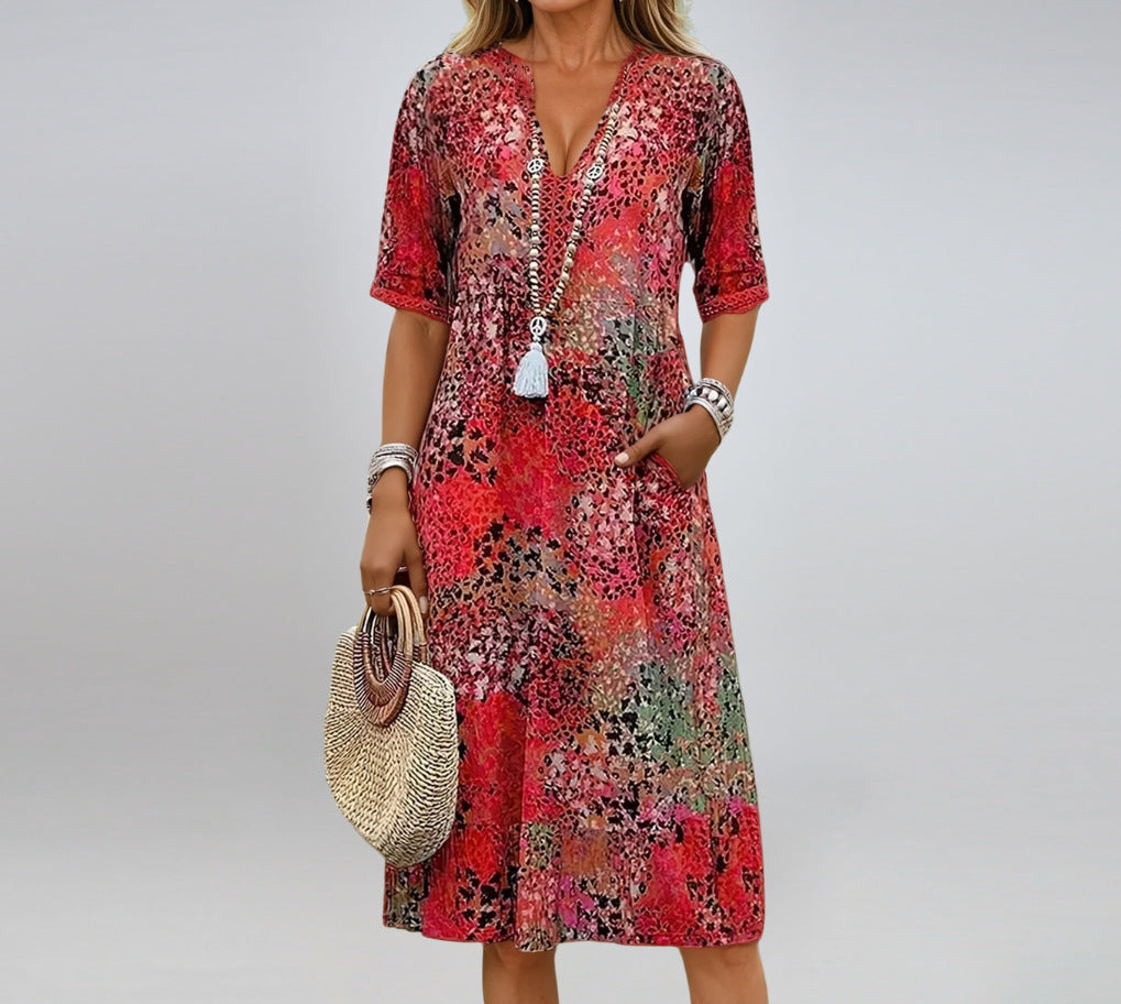 Woman wearing a colorful patterned dress with a plain background