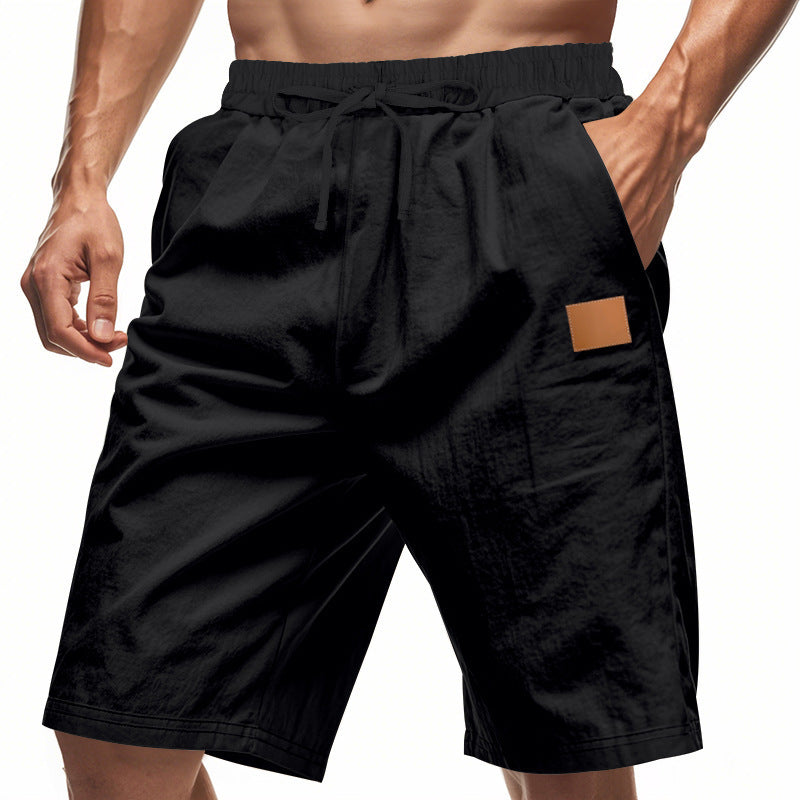 Black shorts with a brown patch on a white background