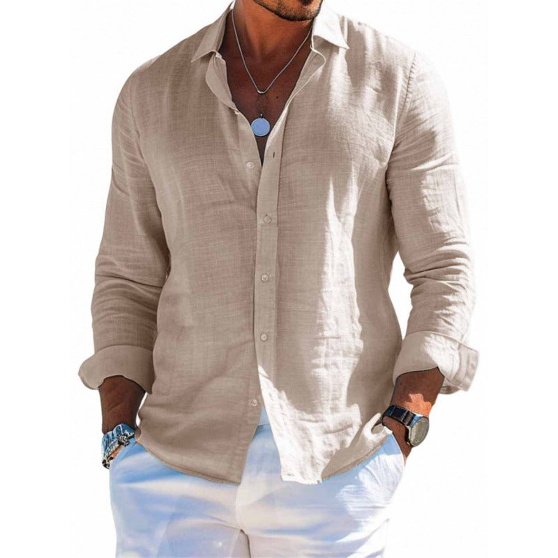 Man wearing a beige button-up shirt and light blue jeans on a white background