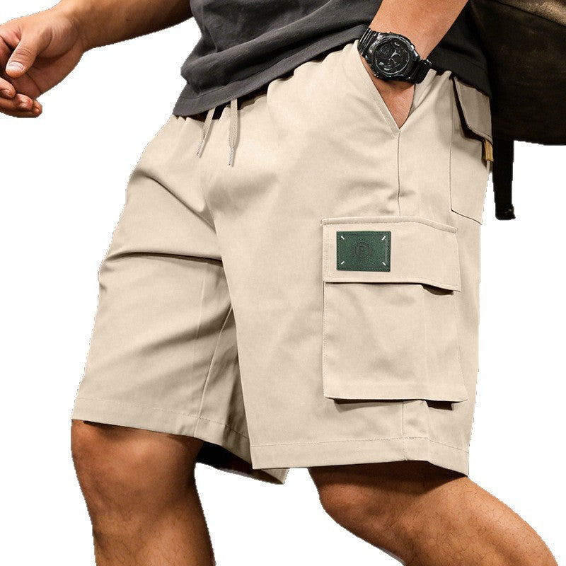 Beige shorts with a pocket detail on a white background