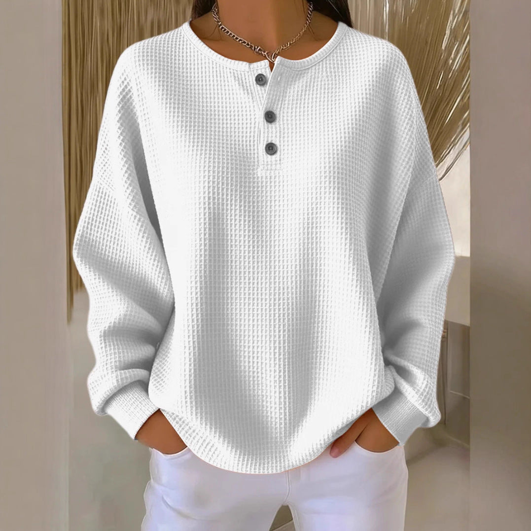 White textured long-sleeve shirt with buttons worn by a person against a neutral background