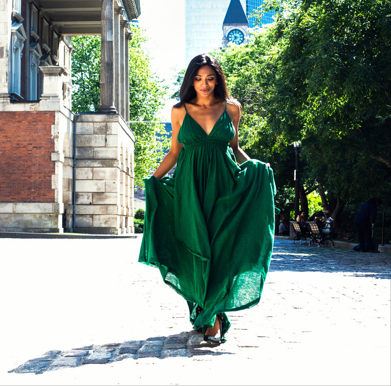 Woman in a flowing green maxi dress walking outdoors — shop women's dresses at ZA-Zola